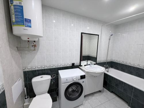 a bathroom with a washing machine and a sink at Готель на Шнеєрсона in Dnipro