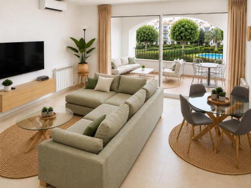 a living room with a couch and a table at Casa Lilo - Renovated 2-Bed Apartment with Pool View - La Torre Golf Resort in Torre-Pacheco