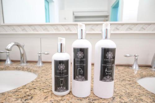 two bottles ofodorizers sitting on a counter in a bathroom at Le Mandala Moris Boutique Hotel in Grand-Baie
