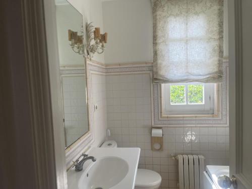 a bathroom with a sink and a toilet and a window at Casa Sierrapando - by Wehomes in Torrelavega