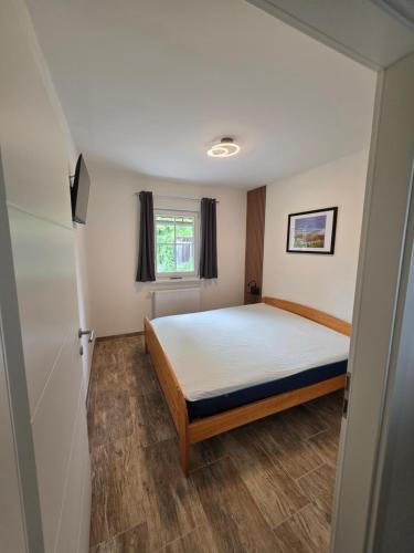a bedroom with a bed and a window at Ferienwohnungen Forever in Gamlitz