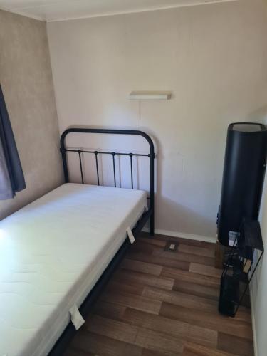 a small room with two beds and a tv at de Tweelingen - de Tien Heugten in Schoonloo