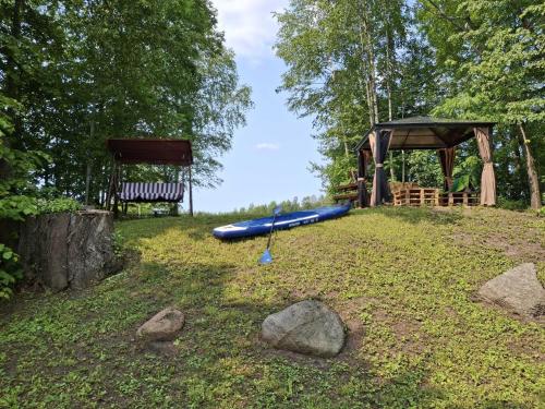 a playground with a blue at Camping "Sīvezers" in Auleja