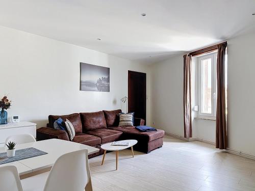 a living room with a couch and a table at EM LIFE COLMAR in Colmar