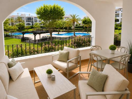 a living room with a view of a pool at Casa Lilo - Renovated 2-Bed Apartment with Pool View - La Torre Golf Resort in Torre-Pacheco