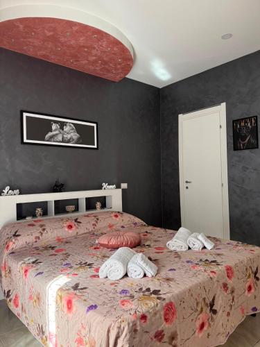 a bedroom with a large bed with pillows on it at Maison D'orleans By Catalano in Palermo