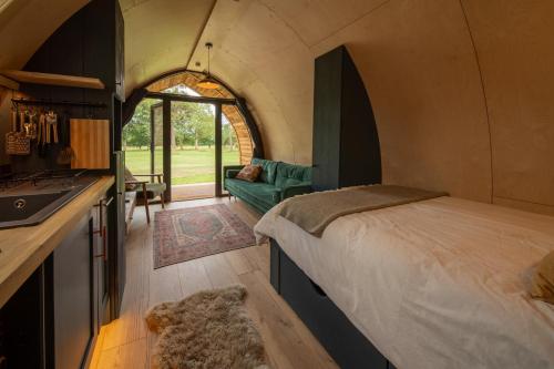 a room with a bed and a kitchen in a tent at Bainton Burrows by Wigwam Holidays in Great Driffield