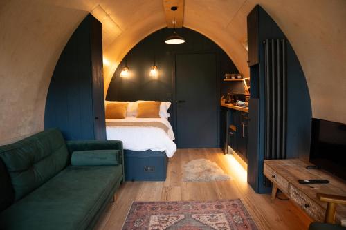 a bedroom with a bed and a couch at Bainton Burrows by Wigwam Holidays in Great Driffield