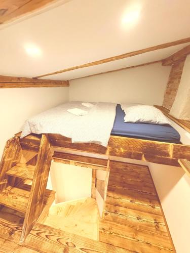 a bunk bed in a room with wooden floors at Apartmán Lotta in Kežmarok