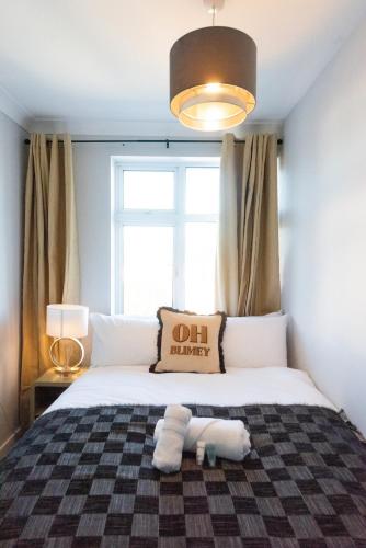 a bedroom with a bed with a pillow and a window at 4BR Braintree Contractor - long stay in Braintree