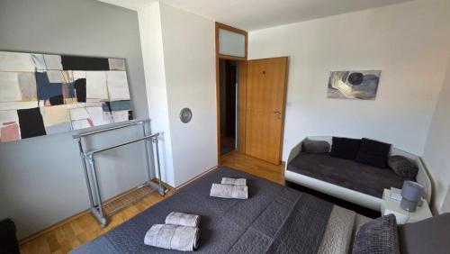 a living room with a bed and a couch at DenVigo in Čakovec
