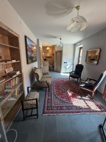 a living room with chairs and a rug at Rifugio Escursionistico Locanda Borgo Villa in Acceglio