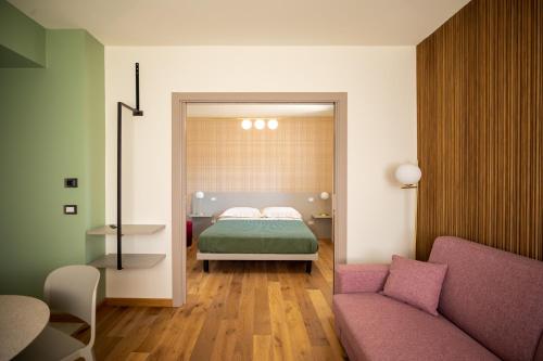 a bedroom with a bed and a couch at Salvia Hotel in Poggio Moiano