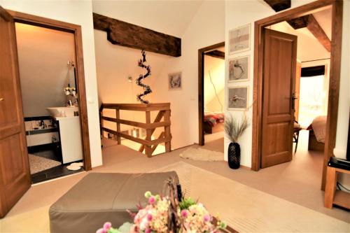 a living room with a room with a stairway at Villa Suzana's Nature Hideout in Gospić