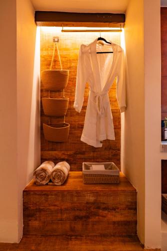 a white shirt is hanging in a closet at Esensia Boutique Studio in Oranjestad