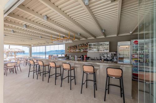 a bar with a row of stools in a restaurant at Golden Sand in Plaka