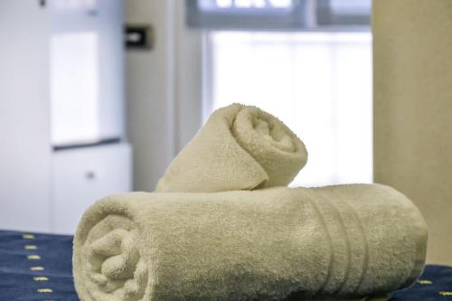 a stack of towels sitting on a table at Albergo Al Carugio in Monterosso al Mare