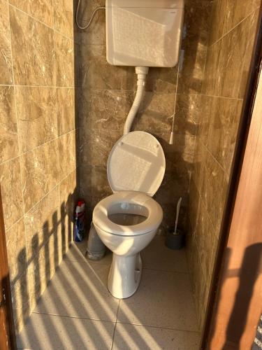 a small bathroom with a toilet in a stall at Lure House in Mali Zvornik