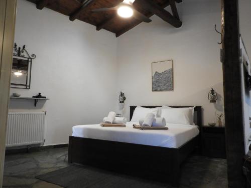 a bedroom with a bed with two towels on it at Olivia traditional stone house in Nikiti