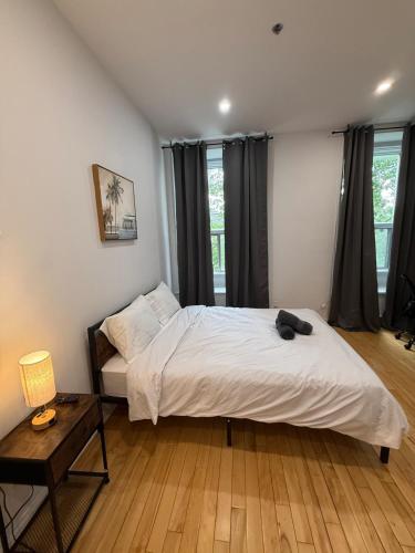 a bedroom with a bed with a cat laying on it at Downtown Studio for 2 with Free private parking in Montreal