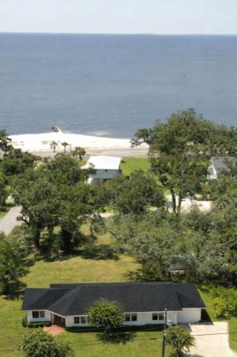an aerial view of a house and a beach at Steps from beach with open fire pit in Gulfport