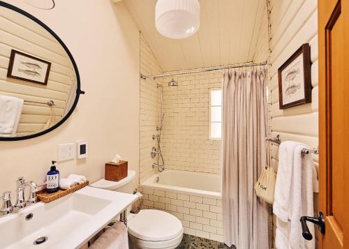a bathroom with a sink and a toilet and a tub at Madeira House in Jenner