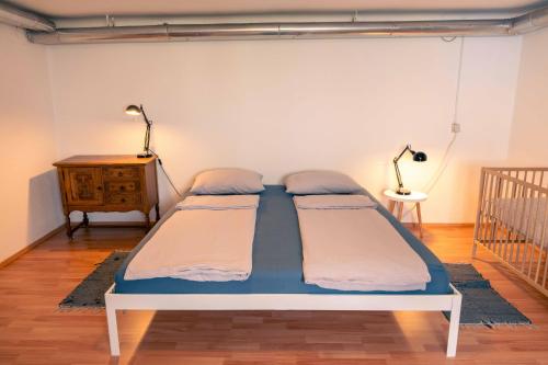 two twin beds in a room with a crib at Mediterranean Family design in Izola