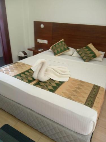 a bedroom with two beds with towels on them at Reach Hotel & Restaurant in Kegalle