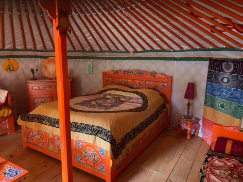 a bedroom with a bed in a tent at Yourte piscine jacuzzi in Gréoux-les-Bains
