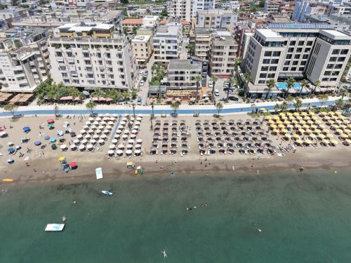 an aerial view of a beach with umbrellas and the ocean at ALEXANDER Luxury Estates in Durrës