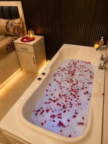 a bath tub filled with blood in a bathroom at Elvora Stay's - Studio with Jacuzzi in Ghaziabad