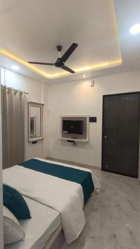 a bedroom with a bed and a ceiling fan at The Hilltop inn in Kelghar
