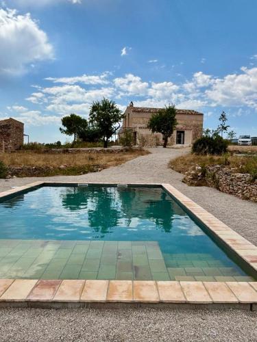 a swimming pool in front of a house at Habitació EL GRANER in Rasquera