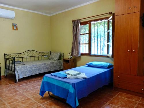 a bedroom with two beds and a window at ΓΑΛΗΝΗ 2 in Litochoro