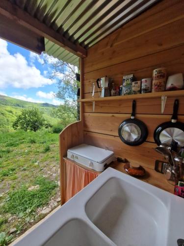 a kitchen with a sink and a view of a field at Ferme équestre de la Molière in Naves