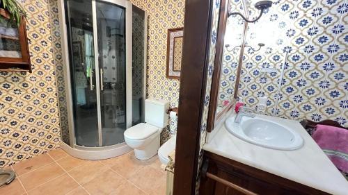 a bathroom with a sink and a shower and a toilet at Drago Luxury Villa in Tarragona