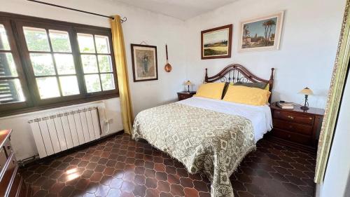 a bedroom with a bed and two windows at Drago Luxury Villa in Tarragona