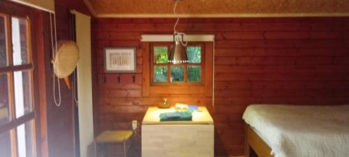 a small bedroom with a bed and a window at Retraitehuisje Westerwolde in Blijham