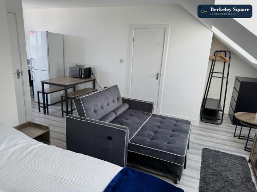 a living room with a couch and a table at New Top Floor Studio Sleeps 3 Very Spacious in Finchley