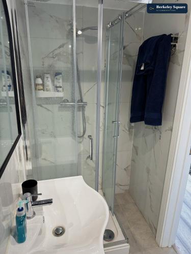 a bathroom with a shower and a white sink at New Top Floor Studio Sleeps 3 Very Spacious in Finchley