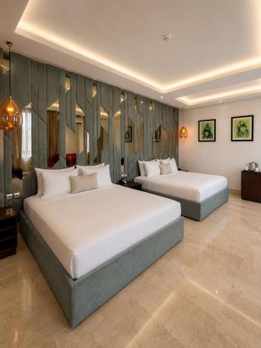 two beds in a hotel room with two beds sidx sidx sidx at One Hotel Casablanca in Casablanca