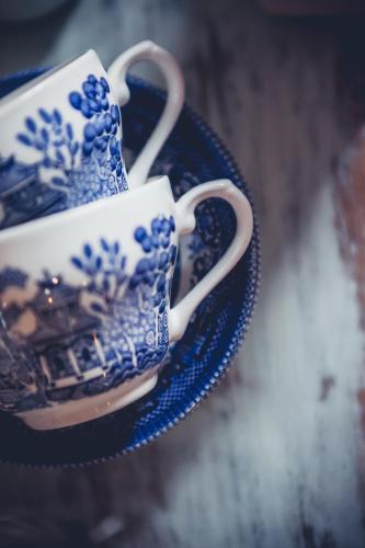 two blue and white cups sitting on a plate at Station House Simondium in Simondium
