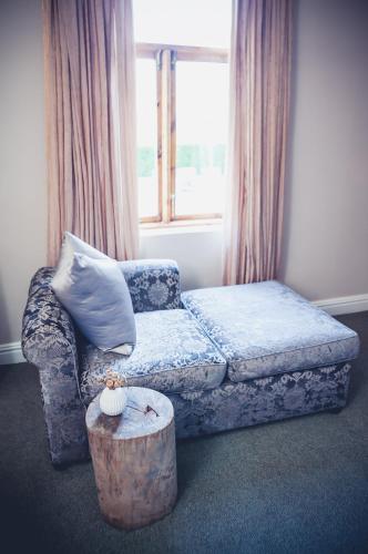a living room with a couch and a coffee table at Station House Simondium in Simondium
