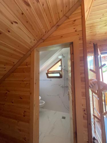 a bathroom in a house with a wooden ceiling at Naimi in Pukë