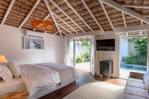 a bedroom with a large bed and a television at Preabeach Boutique Hotel & SPA in Prea