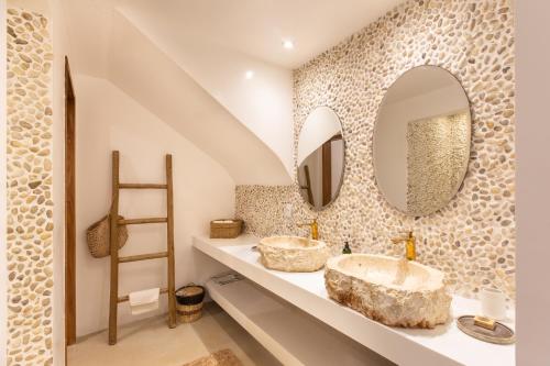 a bathroom with two sinks and two mirrors at Preabeach Boutique Hotel & SPA in Prea