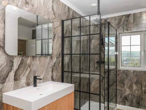 a bathroom with a sink and a mirror at The White House in Okehampton