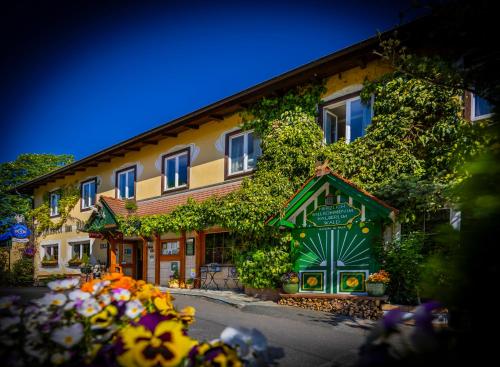 a building with ivy growing on the side of it at Hotel Restaurant - Häuserl im Wald Graz in Graz