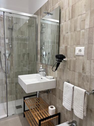 a bathroom with a sink and a shower at I Tetti di Siciliando in Modica