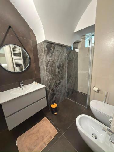 a bathroom with a sink and a shower and a mirror at Moira Luxury Appartament in Bitonto